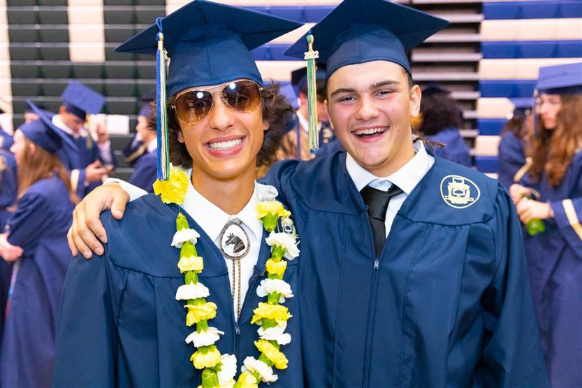 Students wearing blue graduation robes